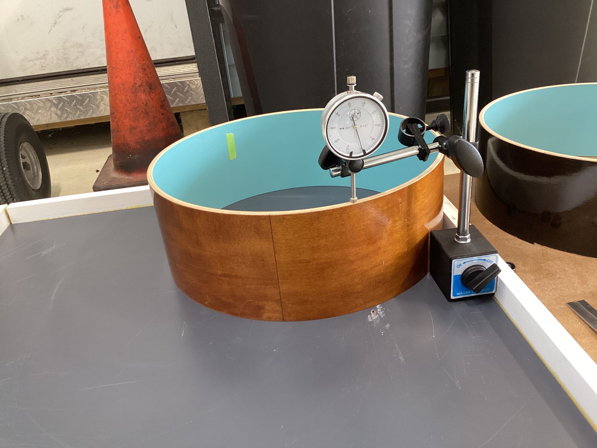A dial indicator checking a shell for flatness