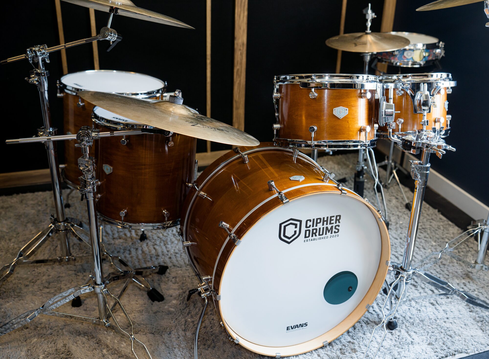 A Cipher Drums kit in the workshop — honey maple, full setup with cymbals