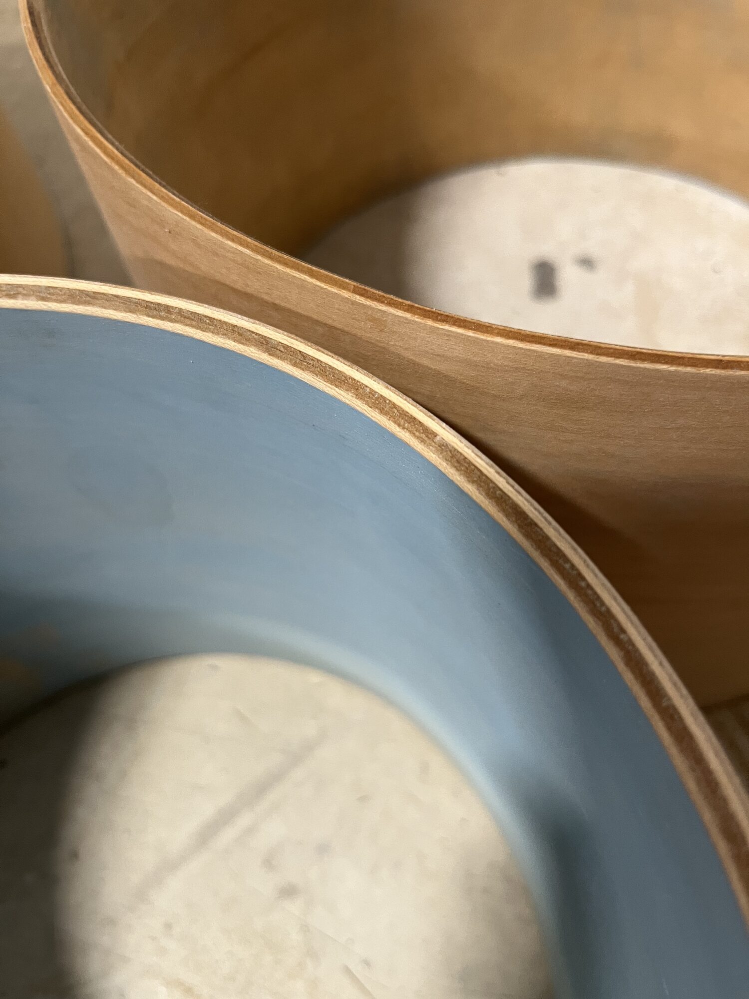 A blue-stained shell next to a natural maple shell